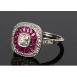 Platinum ruby and diamond set ring, the central diamond with a ruby and diamond surround, ring