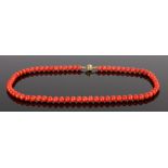 Chinese 8 carat gold and coral bead necklace, the row of beads terminating with an 8 carat gold