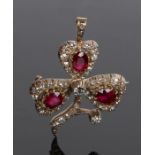 Diamond and ruby set brooch, with three rubies and a diamond surround forming a flower, 2.46 carat