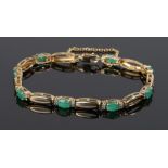 10 carat gold emerald and diamond bracelet, formed from pierced oval links interspersed with oval