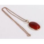 Silver mounted oval pendant set with a red facet cut stone, on a silver necklace, 21.6g