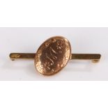 9 carat gold bar brooch, the central oval panel initialled M, 2.2g