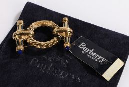 Burberrys of London brooch, the pierced named rope twist effect central ring flanked by two tapering