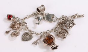 Silver charm bracelet, with twelve charms and heart shaped clasp, 38.6g