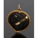 19th Century Chinese gold and carved wood brooch, the heart shaped pendant with carved flowers and