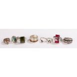 Eight silver rings, to include a rope twist decorated ring, red and green paste set rings etc.