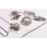 Silver jewellery, to include locket on a necklace, circular brooch with pierced scroll decoration,