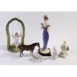 Porcelain figures to include Beswick horse, bisque figure of a young boy on a later swing, figure of