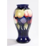 Moorcroft pottery vase, the blue ground with polychrome fruit decoration, 26cm high