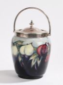 Moorcroft pottery biscuit barrel, with a silver plated handle and top above the blue body with fruit