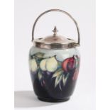 Moorcroft pottery biscuit barrel, with a silver plated handle and top above the blue body with fruit