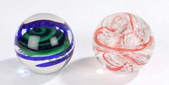 Two Langham glass paperweights, decorated with various colours and bubble inclusions, marked to