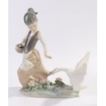 Lladro figure, young girl with a basket of eggs, her dress being pulled by a goose, 20.5cm high