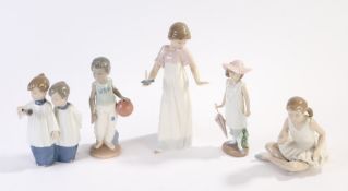 Five Nao porcelain figures, girl with chamber stick, 25cm high, seated ballerina, 14cm high, girl