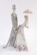 Lladro porcelain figure depicting a lady holding a parasol with a dog at her feet and gentleman in a