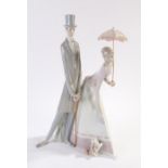 Lladro porcelain figure depicting a lady holding a parasol with a dog at her feet and gentleman in a