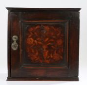 17th Century oak and inlaid spice cupboard, the rectangular cupboard with a square panelled door
