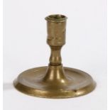 16th Century French brass candlestick, the shortened candle socket on a tapering stem leading down