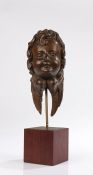 Small late 17 Century oak carved head of an Angel, Flemish, circa 1680, the head facing forwards