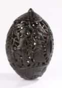 George III carved bugbear coconut, the pierced body with figures among flowers and trees, a money