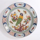 18th Century Dutch Delft polychrome plate, decorated with a parrot on a branch with flowers and