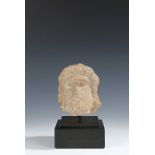 Medieval limestone head, 14th Century, the small size head with long hair and a beard, 13cm high