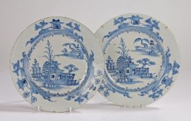 Pair of 18th Century English Delft plates, with a pagoda and trees set among water, the rim of the