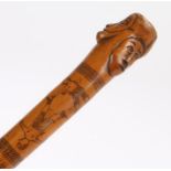 Late 19th Century Folk Art walking stick, the stick carved with raised faces, an etched boxing scene