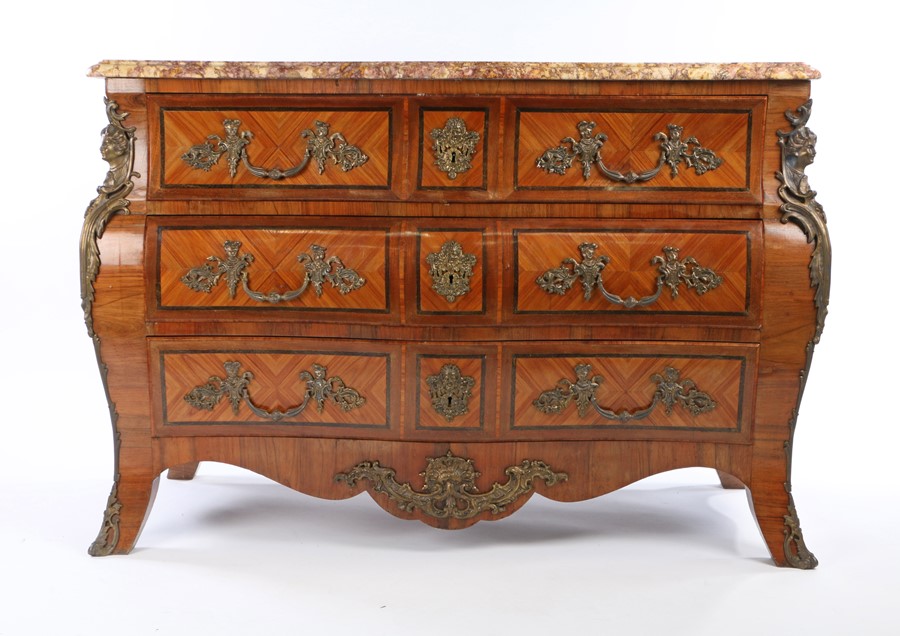 19th Century French tulipwood commode, the serpentine marble top above the bombe base with three