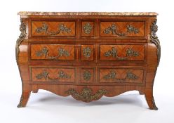 19th Century French tulipwood commode, the serpentine marble top above the bombe base with three