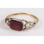 Early 18th Century gold ring, set with a central garnet flanked by clear stones, ring size K 1/2
