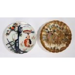 Two Japanese porcelain plates, the first a Satsuma example with figures around a horse AF, 30cm