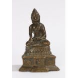 Chinese bronze buddha, seated position above a steeped base, 12cm high