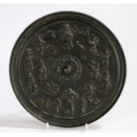 Japanese Meiji period bronze mirror, with a figural and object design to include immortals and