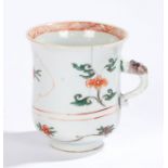 Chinese porcelain famille verte mug, Kangxi, with a flared lip above blue and red flowers and a