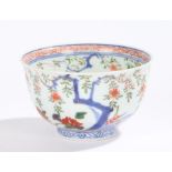 Chinese porcelain bowl, Kangxi, the inner rim decorated in red swirls above branches and gilt