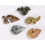 Collection of five Chinese pendants, each carved in hardstone with pieced holes, 60mm long up to