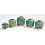 Collection of five Chinese green glaze ginger jars, each with panels depicting flowers, trees and
