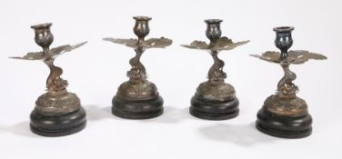 Set of four silver Vietnamese candlesticks, the sconce above a leaf and dragon, 19cm high, (4)