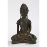 Chinese bronze buddha, with legs folded above a shallow plinth base, 21cm high