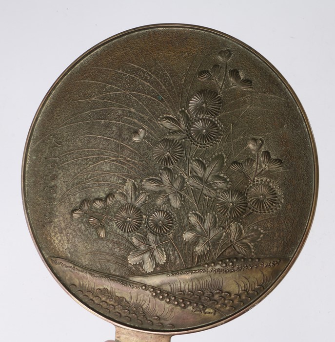 Japanese Edo period bronze hand held mirror, decorated with flowers and Japanese text, 21cm - Image 2 of 2