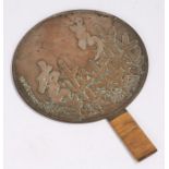 Japanese Edo period bronze hand held mirror, decorated with trees and text, 23cm diameter