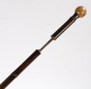 19th Century rhinoceros horn sword stick, the rhinoceros horn ball end above a silver collar assayed