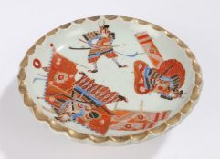 Japanese Meiji period porcelain dish, with Samurai to the top raised on flower decorated supports,