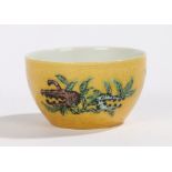 Chinese porcelain wine cup, with yellow glaze and fruit, seal mark to the base, 65mm diameter