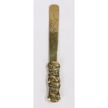 Japanese brass letter opener, the handle with a pile of Noh masks, 28cm long