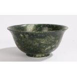 Chinese hardstone bowl, in green and white with an arched lip, 10cm diameter