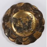 Japanese alloy dish, with two fighting samurai on horseback, heightened in gilt, 18.5cm diameter