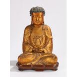Chinese gilt lacquered wood figure of Buddha, Qing Dynasty, the pointed hair whorls framing a red