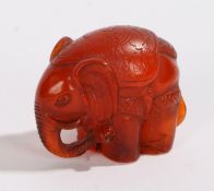 Japanese netsuke, the amber effect elephant signed to the base, 30mm high